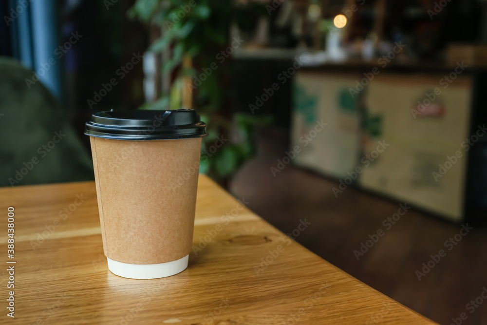 Cup of hot coffee on table in cafe