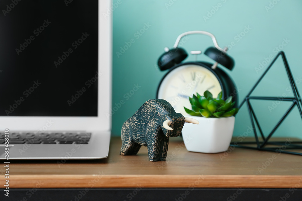 Figurine of bull as symbol of year 2021 on table in room