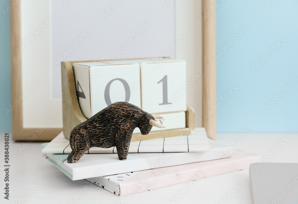 Figurine of bull as symbol of year 2021 on table in room