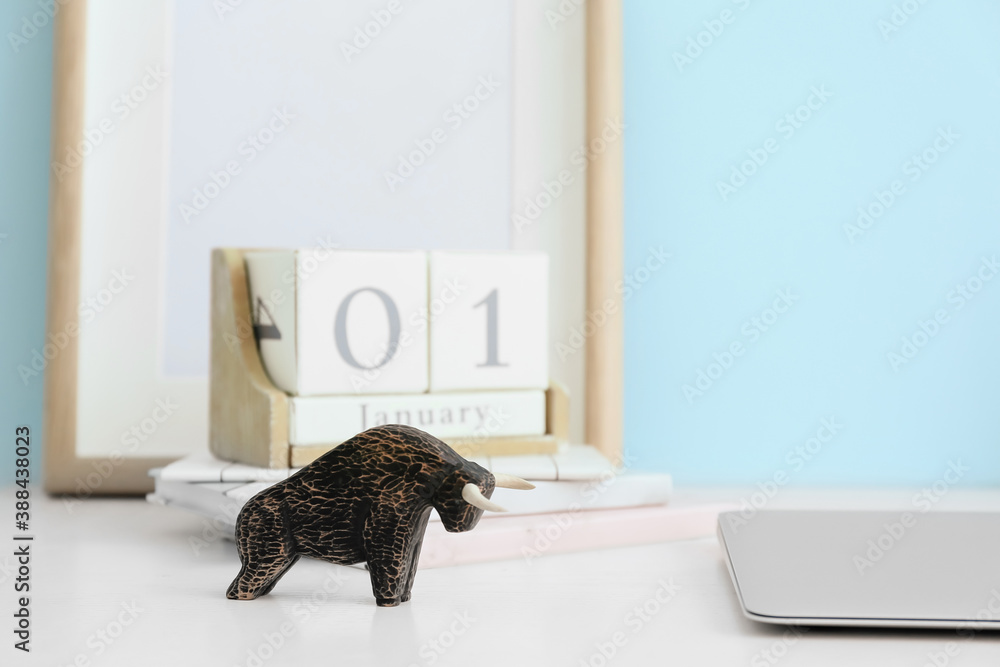 Figurine of bull as symbol of year 2021 on table in room