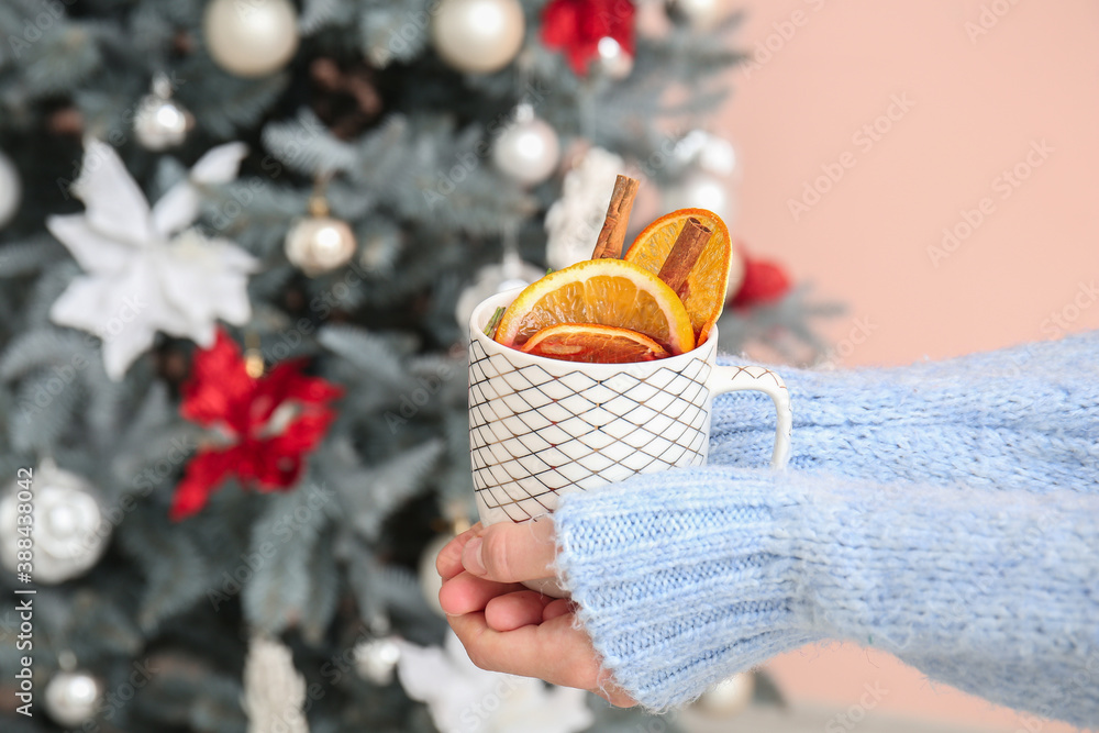 Woman drinking mulled wine at home