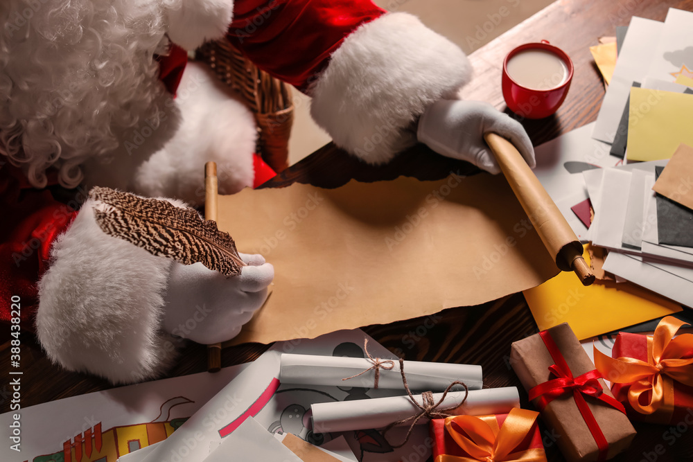 Santa Claus writing letter at home on Christmas eve