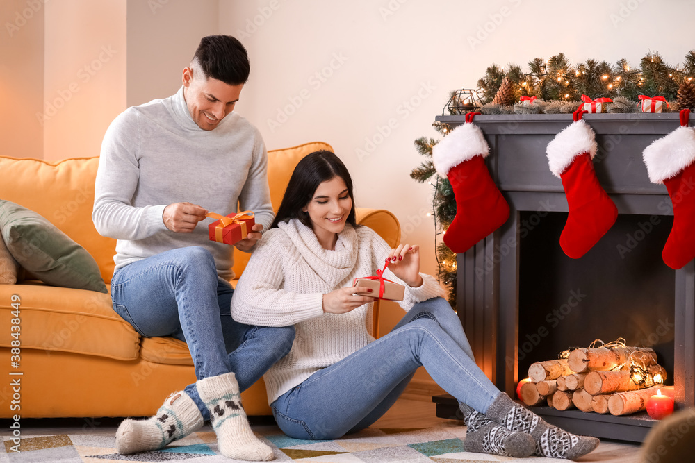 Happy young couple celebrating Christmas at home