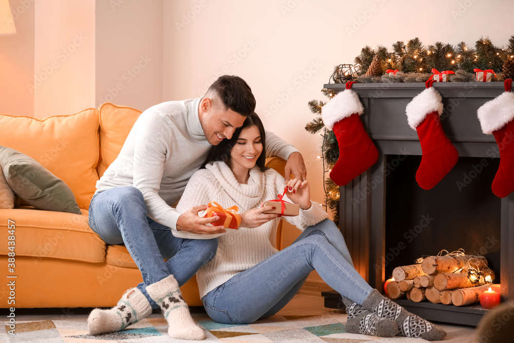 Happy young couple celebrating Christmas at home