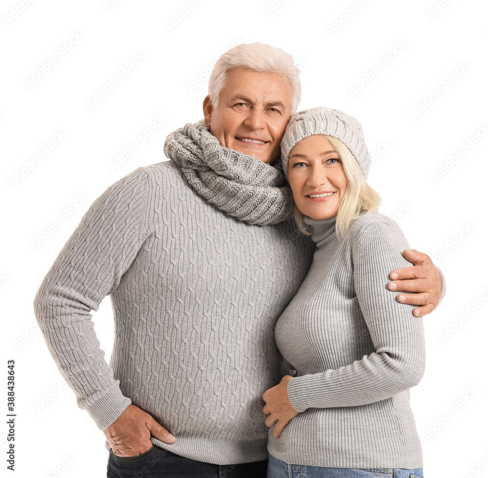 Mature couple in winter clothes on white background