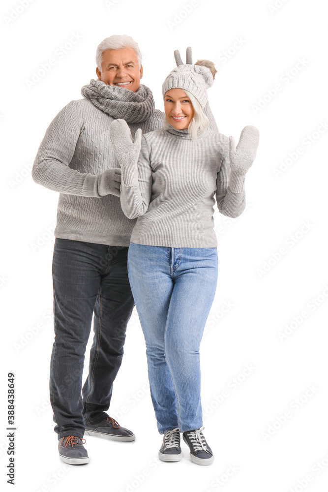 Mature couple in winter clothes on white background