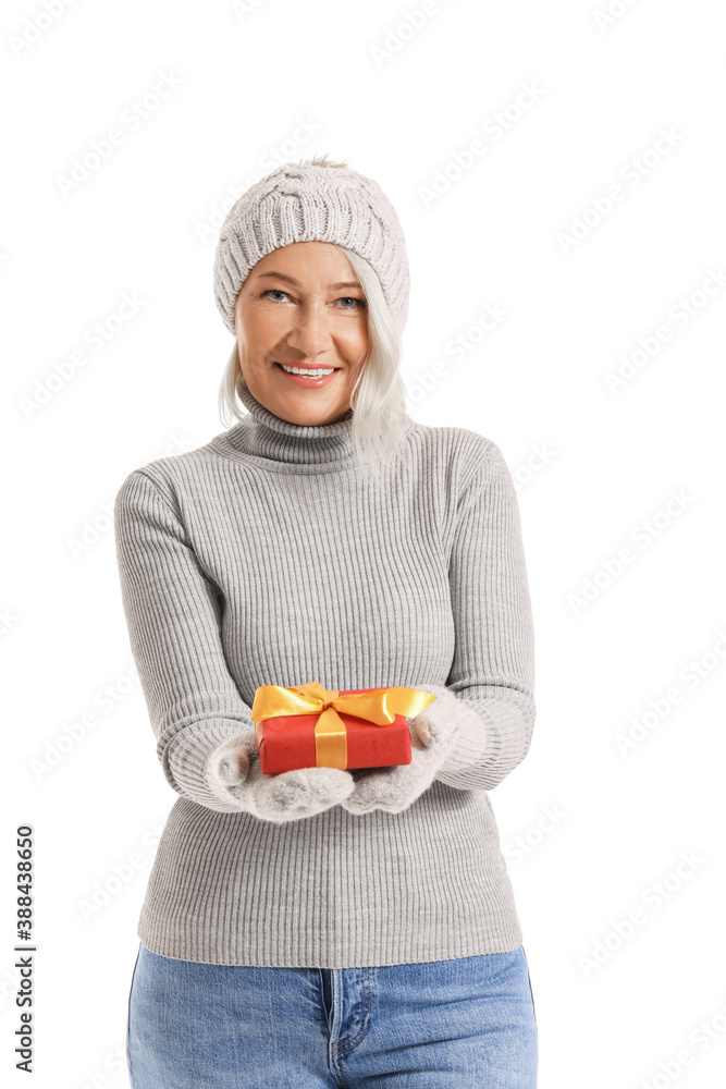 Mature woman with Christmas gift on white background