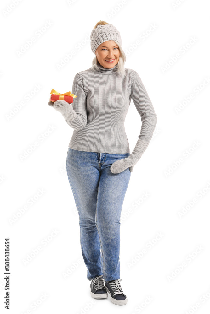 Mature woman with Christmas gift on white background