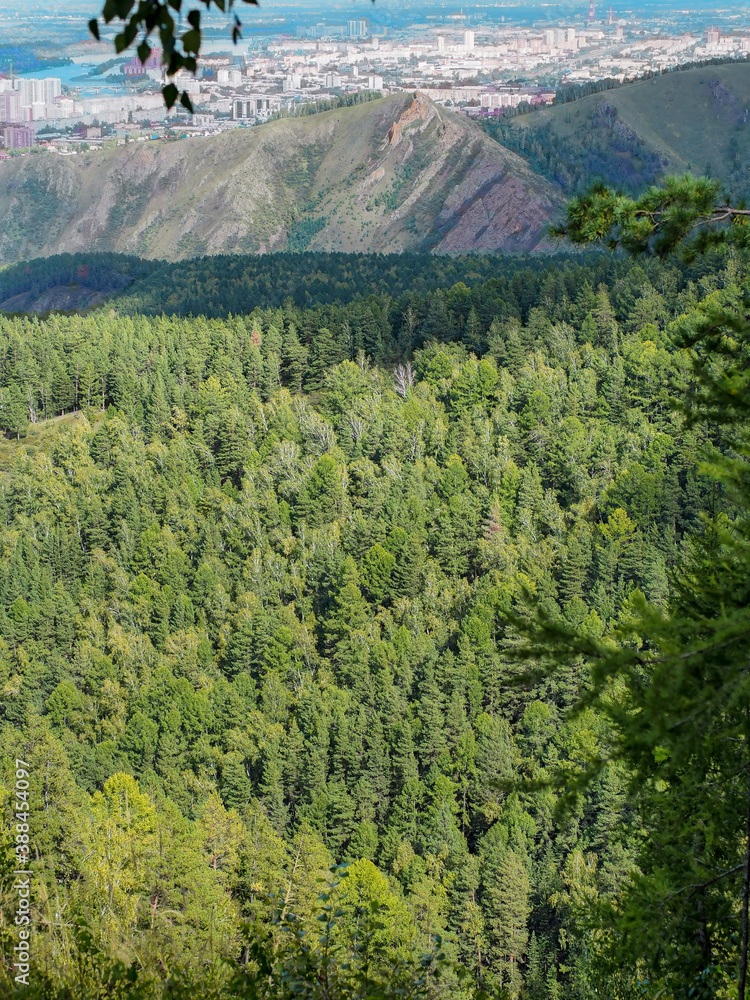 A view from reserve `The Pillars` to siberian city of Krasnoyarsk Russia with autumn forest on a for