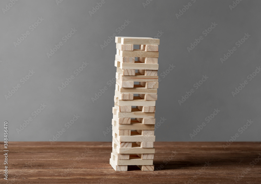 Tower from wooden blocks standing on table