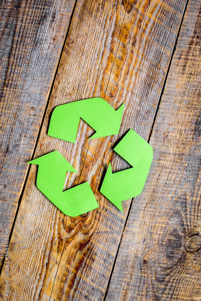 recycling symbol in eco concept on wooden background top view mockup