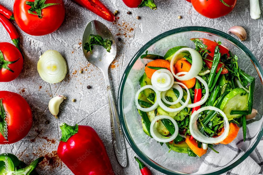 cooking vegetables on the stone background top view