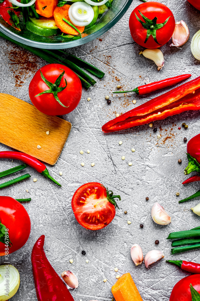 cooking vegetables on the stone background top view