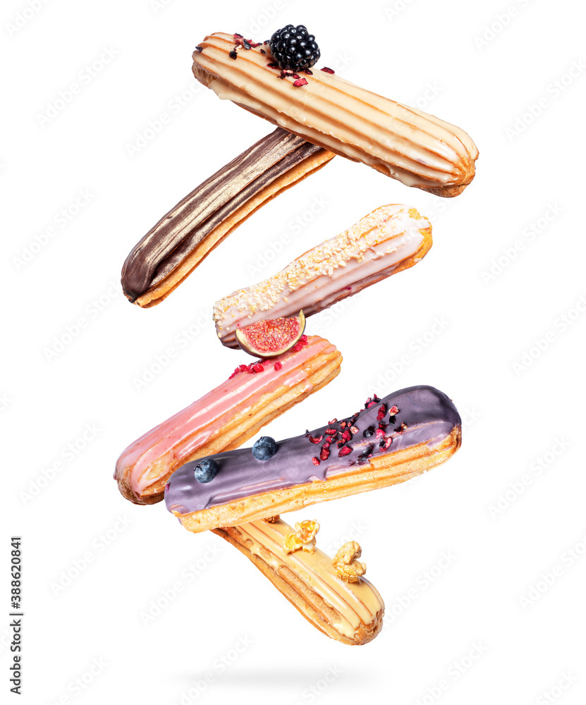 Delicious eclairs with different flavors in the air, isolated on a white background