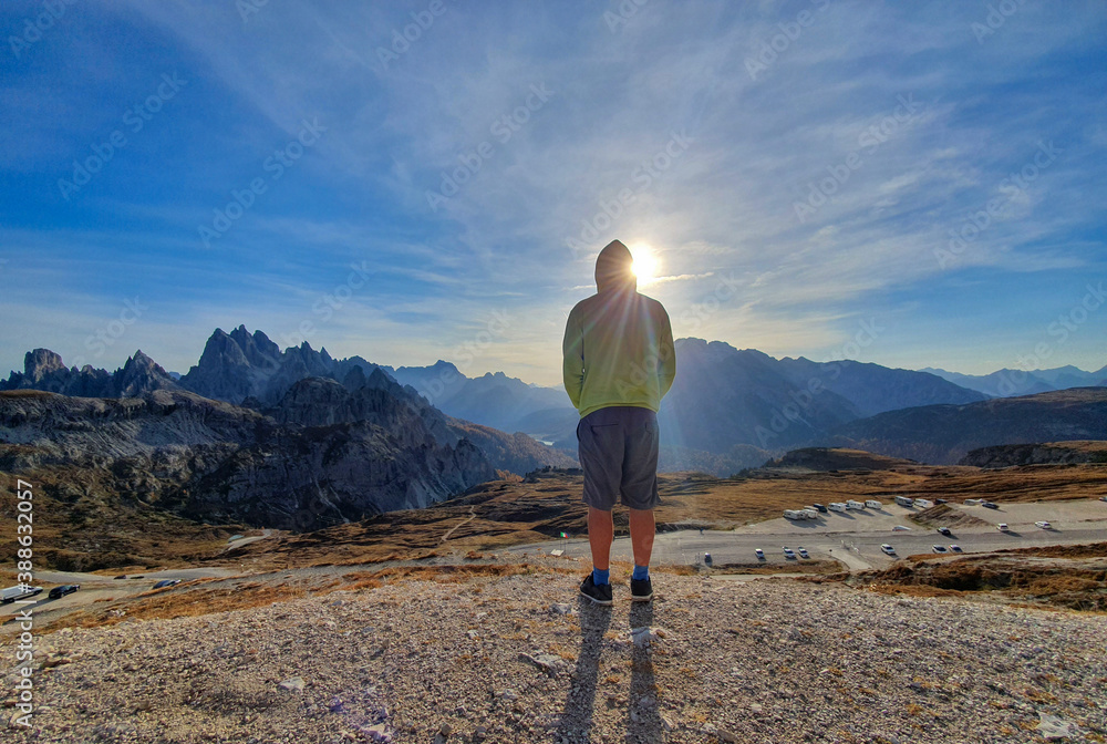 LENS FLARE: Male tourist on road trip across Dolomites stops to observe Tre Cime