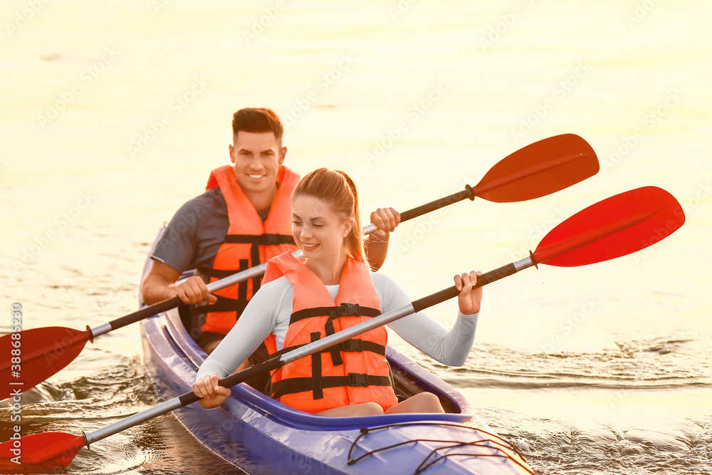 Young couple kayaking in river