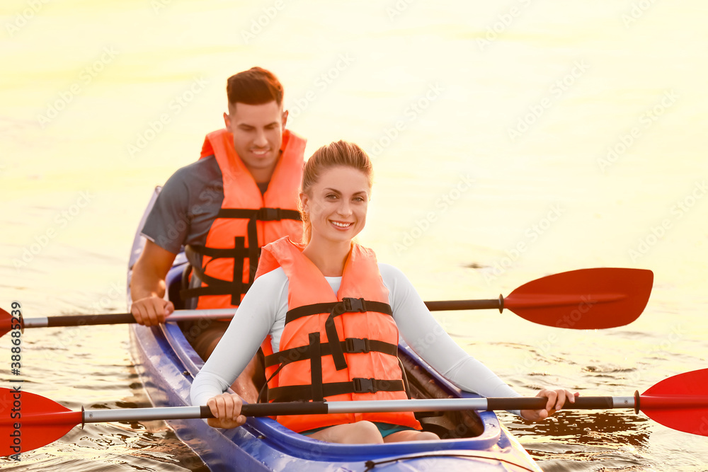 Young couple kayaking in river