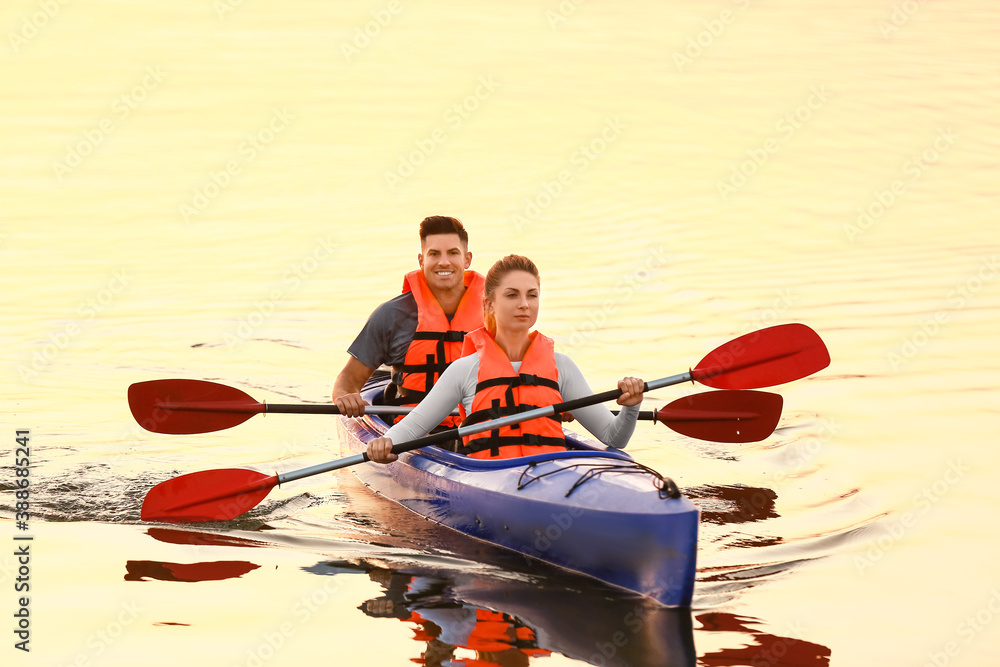 Young couple kayaking in river