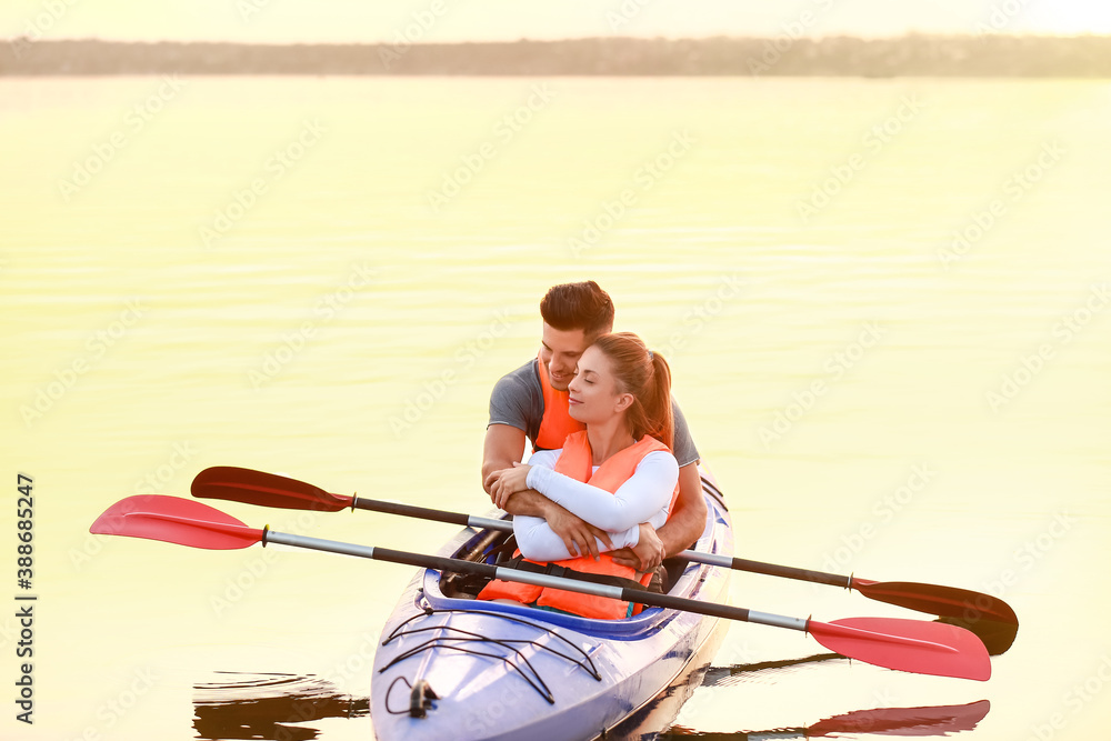 Young couple kayaking in river