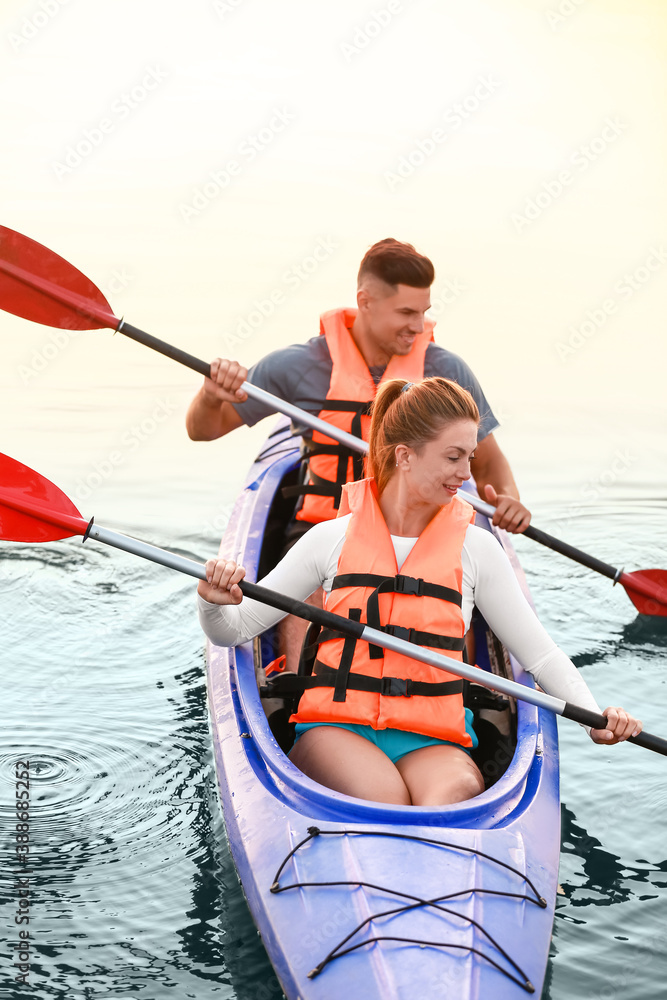 Young couple kayaking in river