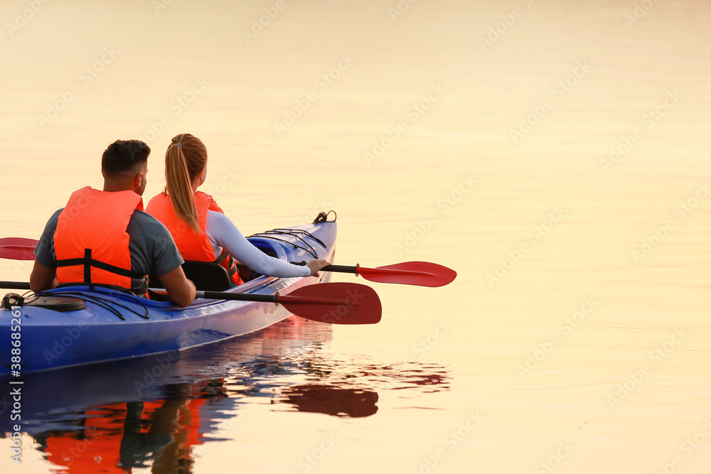 Young couple kayaking in river