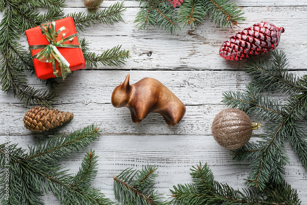 New Year composition with figurine of bull on wooden background