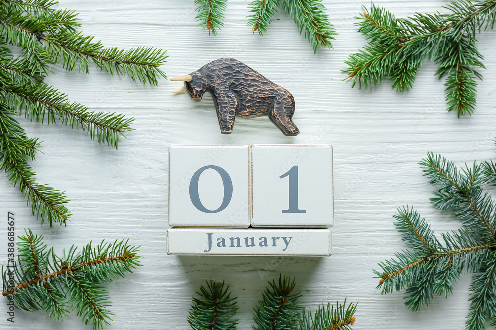 New Year composition with figurine of bull on wooden background