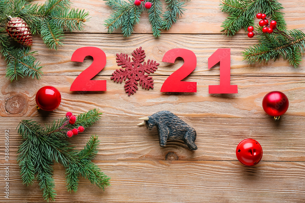 New Year composition with figurine of bull on wooden background