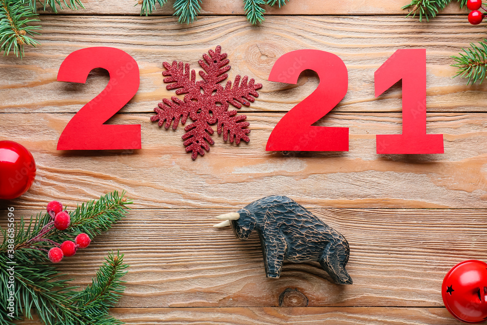 New Year composition with figurine of bull on wooden background