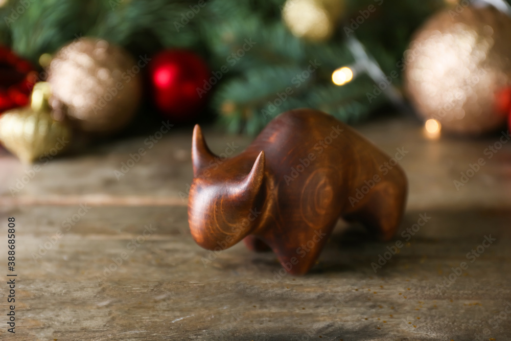 Figurine of bull as symbol of year 2021 on wooden table