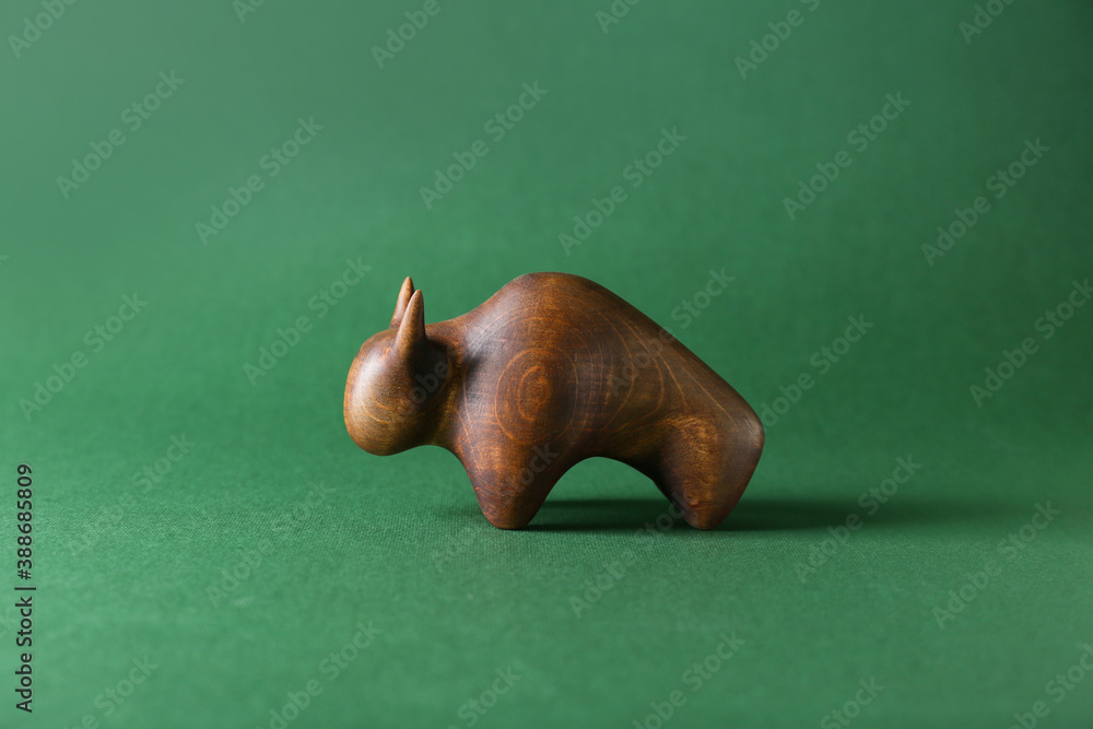 Figurine of bull as symbol of year 2021 on color background