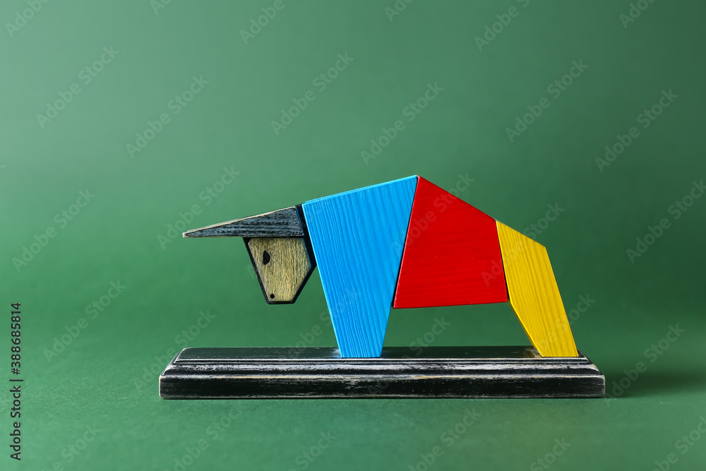 Figurine of bull as symbol of year 2021 on color background