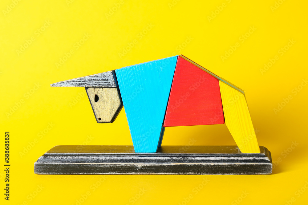 Figurine of bull as symbol of year 2021 on color background