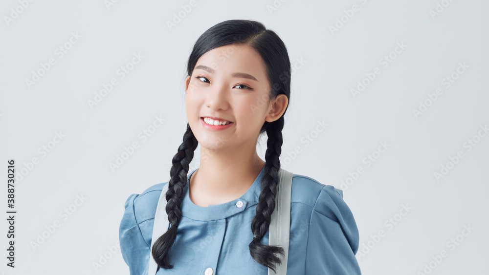 Indoor photo of college student girl isolated on white background, wearing backpack, ready to go to 