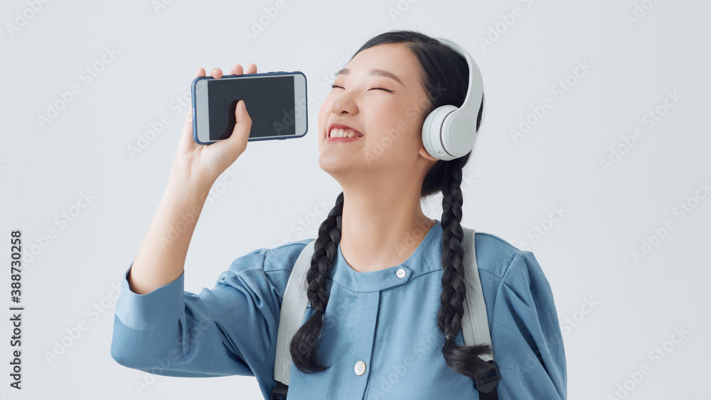 portrait of pretty girl singing like mic cell having fun isolated over white background