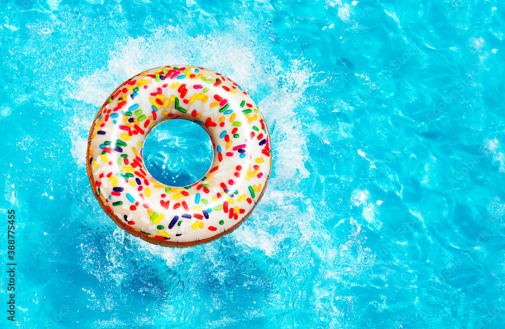 Inflatable candy doughnut buoy splash into the swimming pool view from above