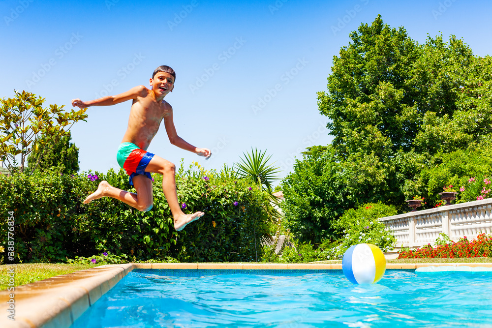 Happy little boy jump in the water diving after long run laugh and smile profile view