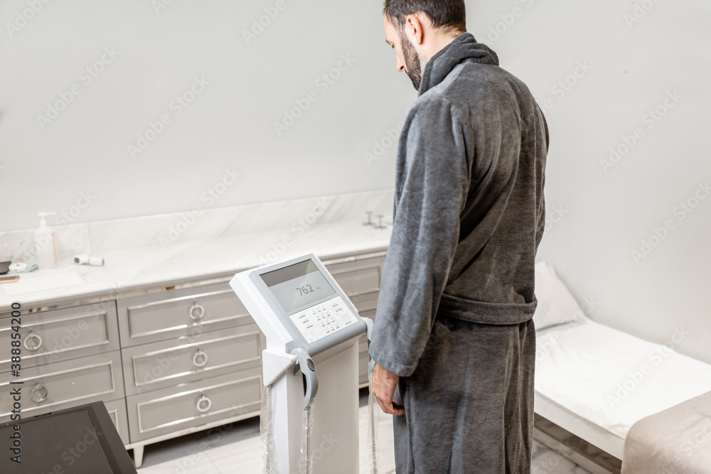 Man measuring body composition balance, standing on the medical scales during Inbody test at the lux