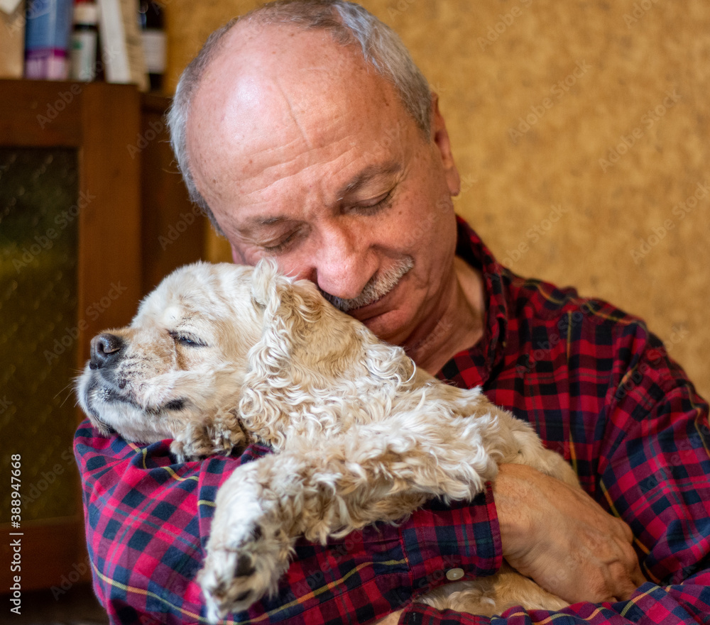 Senior man hugging american cocker spaniel