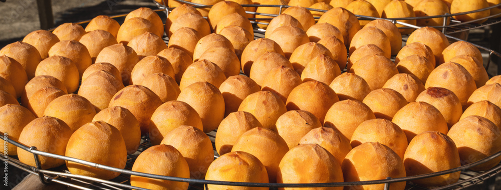 Making process of sun exposuring dried persimmon in a sieve in autumn.