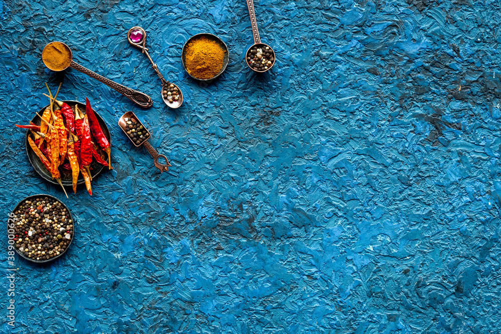 Spices and condiments in metal bowls and spoons. Overhead view