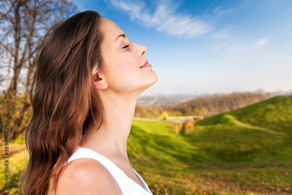 Happy young woman with perfect skin on outdoor background