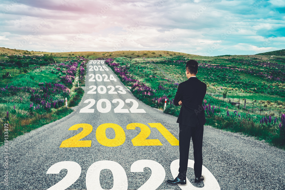 The 2021 New Year journey and future vision concept . Businessman traveling on highway road leading 