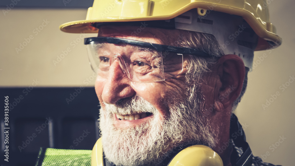 Senior factory worker or engineer close up portrait in factory . Industry and engineering concept .