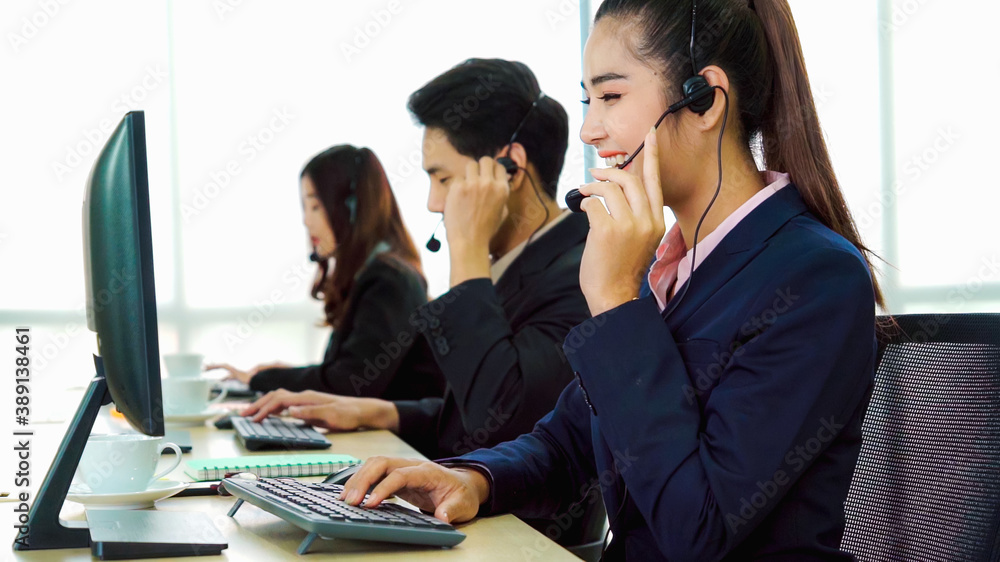 Business people wearing headset working in office to support remote customer or colleague. Call cent