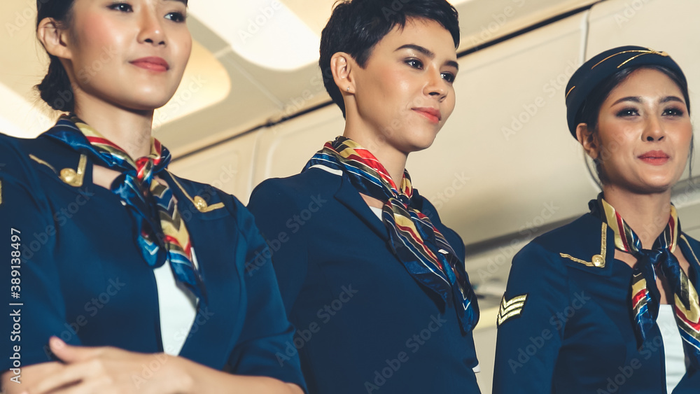 Cabin crew dancing with joy in airplane . Airline transportation and tourism concept.