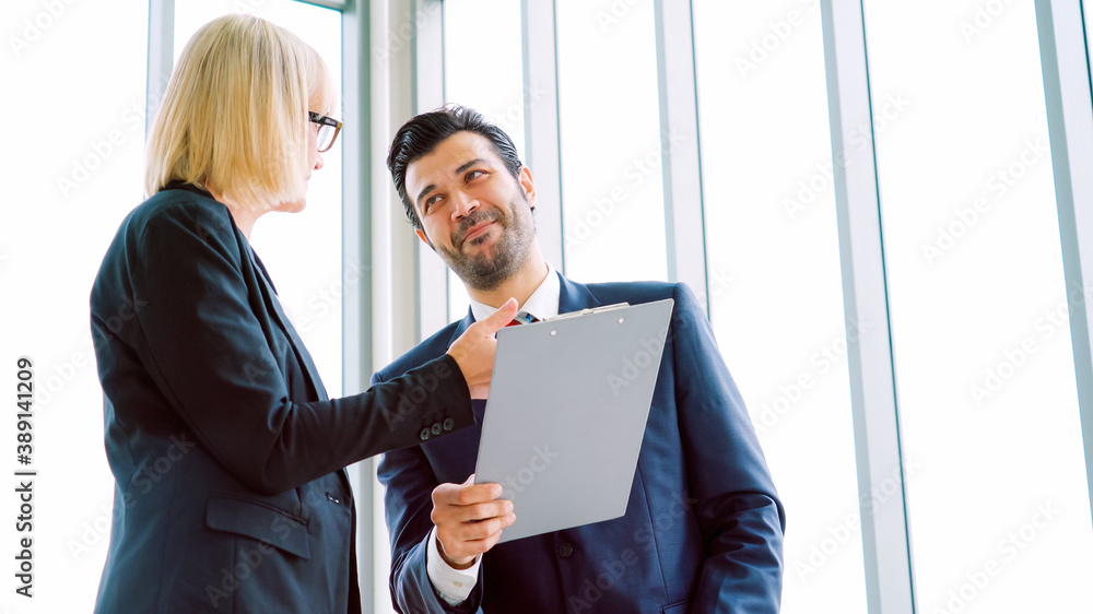 Two business people talk project strategy at office meeting room. Businessman discuss project planni