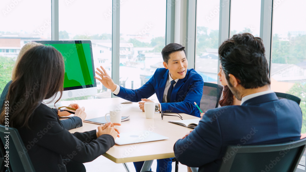 Business people in the conference room with green screen chroma key TV or computer on the office tab