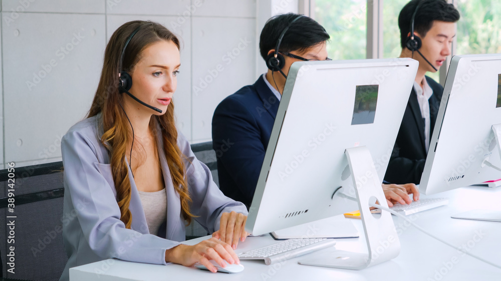 Business people wearing headset working in office to support remote customer or colleague. Call cent