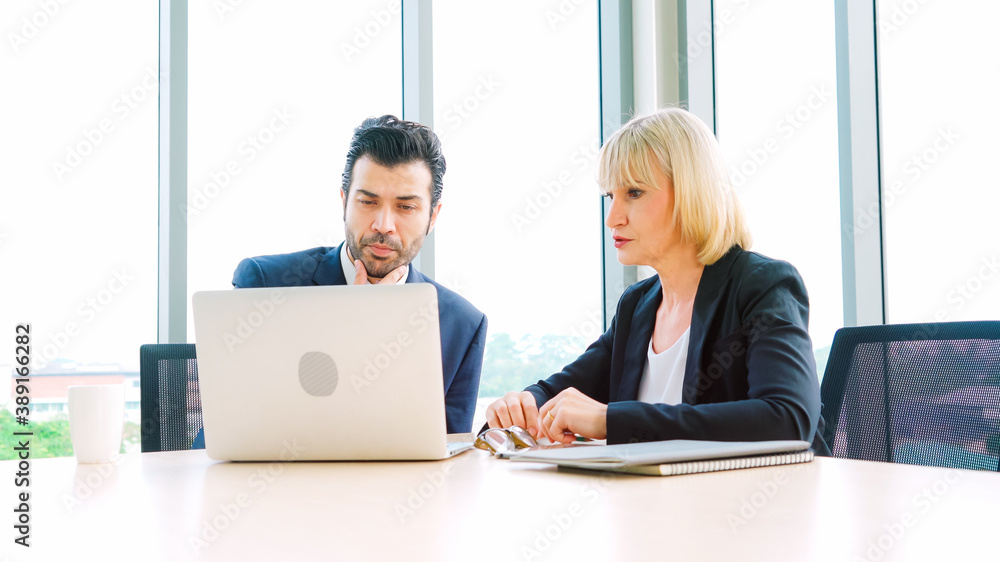 Two business people talk project strategy at office meeting room. Businessman discuss project planni